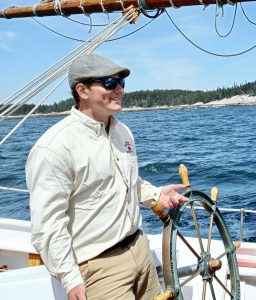 Captain Tyler King at the helm of the American Eagle.